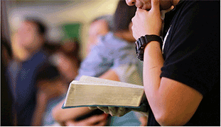Photo of man reading a bible